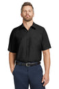 Man wearing a black short-sleeve shirt and navy pants on a white background embroidered Red Kap® Short Sleeve Industrial Work Shirt
