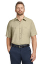 Man wearing a beige short-sleeve shirt and navy pants on a white background embroidered Red Kap® Short Sleeve Industrial Work Shirt