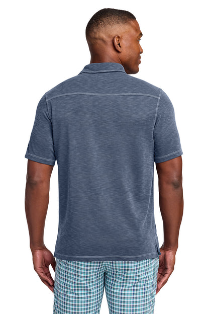 Man wearing a blue polo shirt and plaid shorts on a white background, Tommy Bahama® Palmetto Paradise Polo, Embroidered
