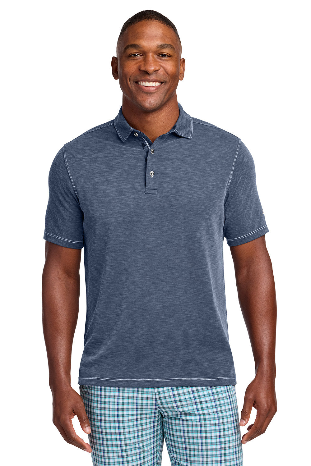 Man wearing a blue polo shirt and plaid shorts on a white background, Tommy Bahama® Palmetto Paradise Polo, Embroidered