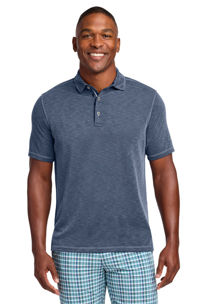 Man wearing a blue polo shirt and plaid shorts on a white background, Tommy Bahama® Palmetto Paradise Polo, Embroidered