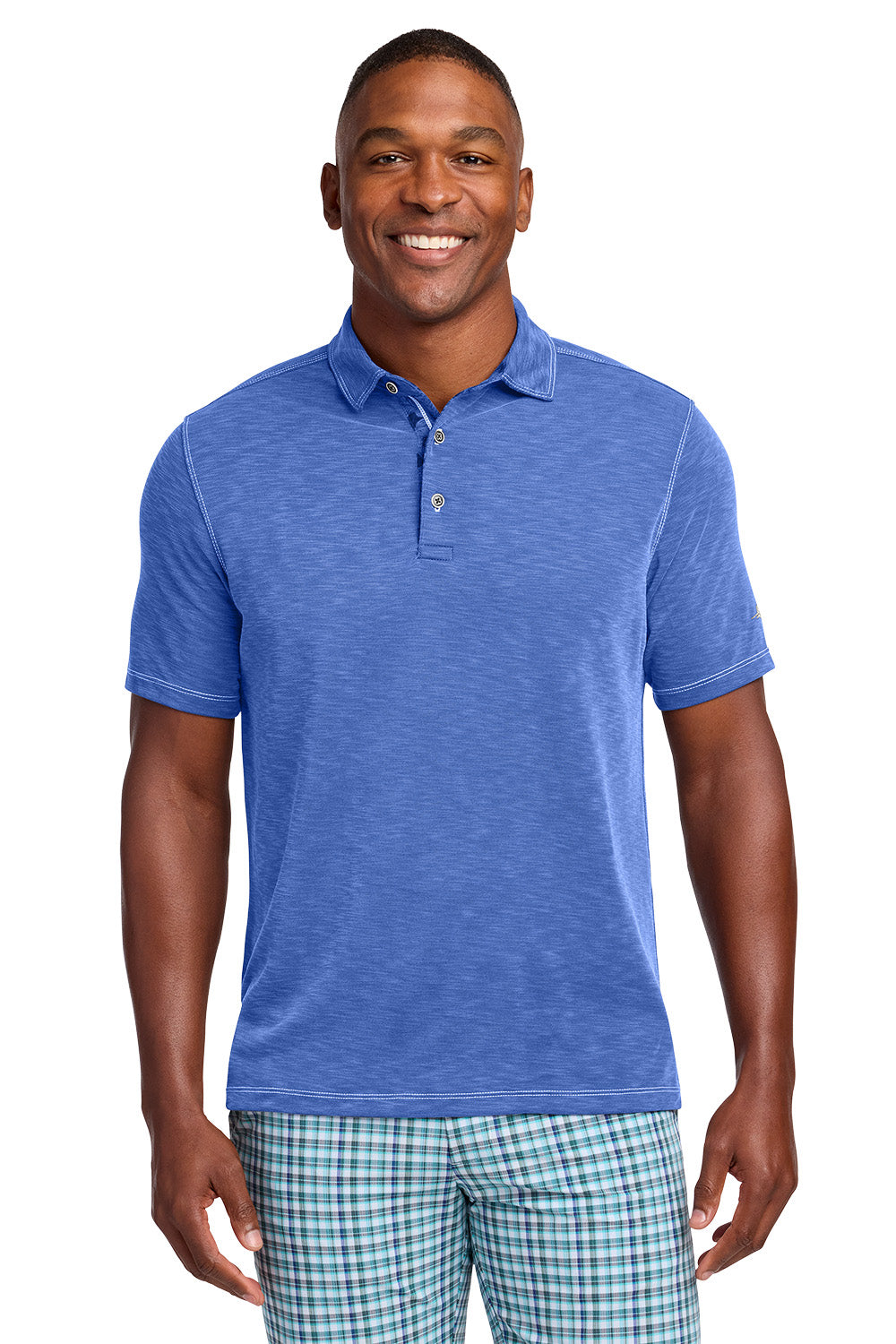 Man wearing a blue polo shirt and plaid shorts on a white background, Tommy Bahama® Palmetto Paradise Polo, Embroidered