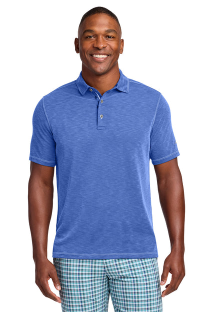 Man wearing a blue polo shirt and plaid shorts on a white background, Tommy Bahama® Palmetto Paradise Polo, Embroidered