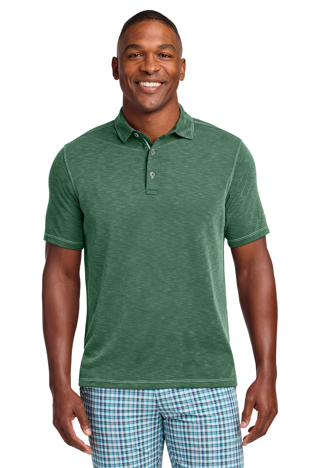 Man wearing a green polo shirt and plaid shorts on a white background, Tommy Bahama® Palmetto Paradise Polo, Embroidered