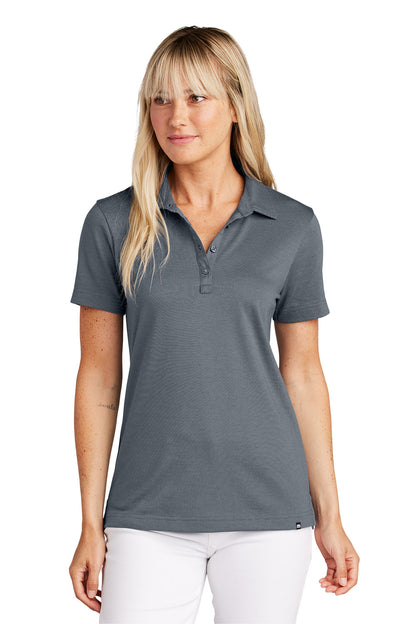 Woman wearing a gray polo shirt on a white background, Embroidered TravisMathew Women's Sunnyvale Polo