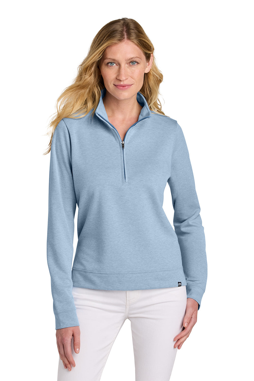 Woman wearing a light blue pullover with a quarter zip on a white background TravisMathew Women's Coveside 1/2-Zip, Embroidered