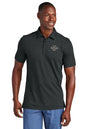 Man wearing a dark gray polo shirt with customizable text on a white background, Embroidered TravisMathew Sunnyvale Polo