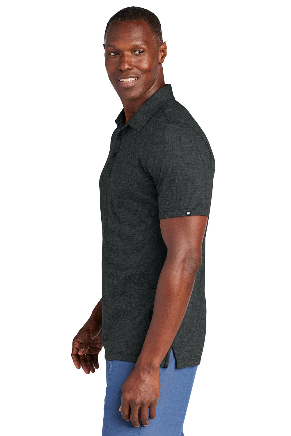 Man wearing a dark gray polo shirt on a white background, Embroidered TravisMathew Sunnyvale Polo