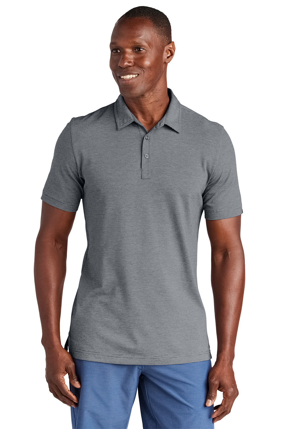 Man wearing a gray polo shirt and blue pants on a white background, Embroidered TravisMathew Sunnyvale Polo