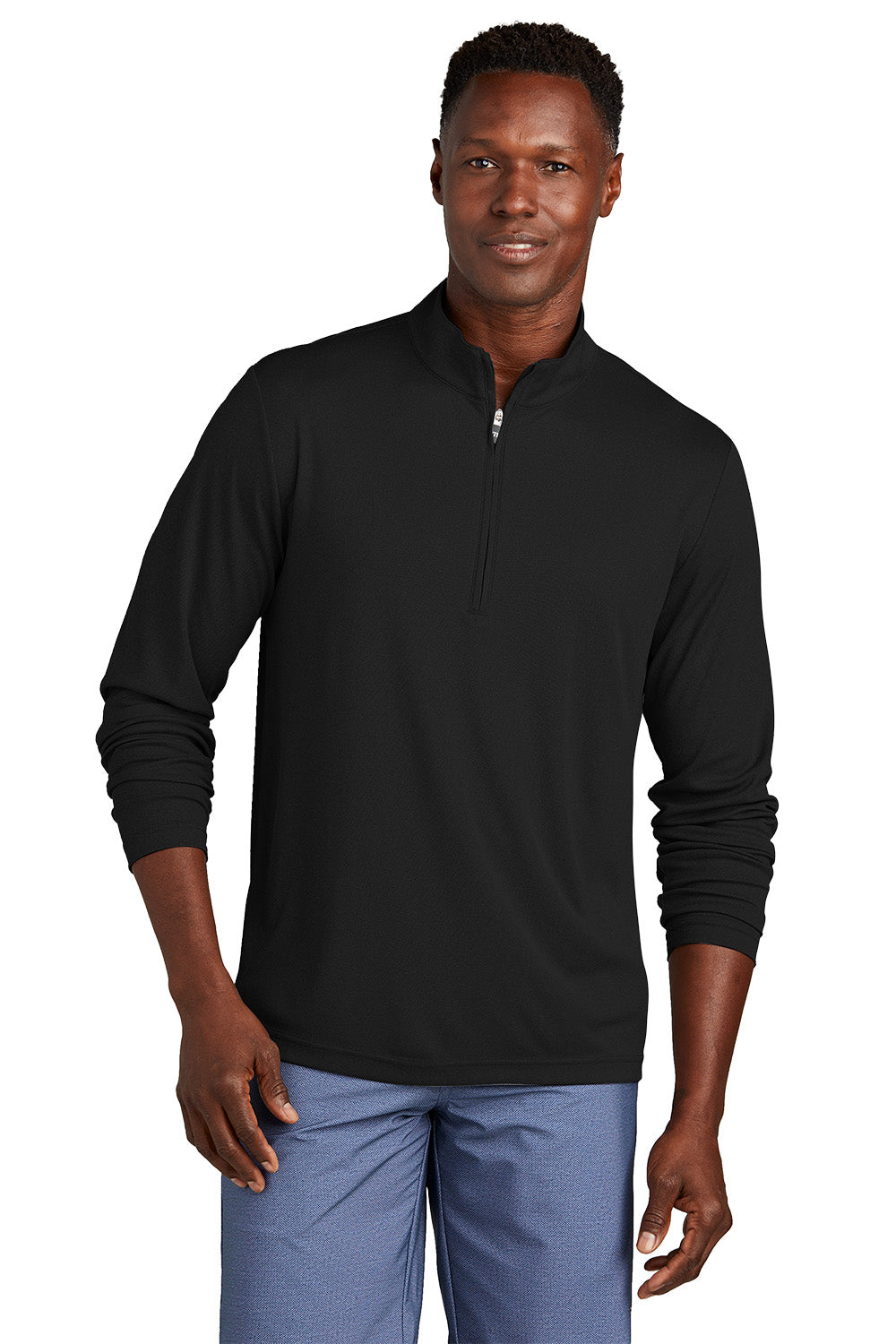 Man wearing a black long-sleeve shirt with a quarter zip on a white background, embroidered TravisMathew Coto Performance 1/4-Zip