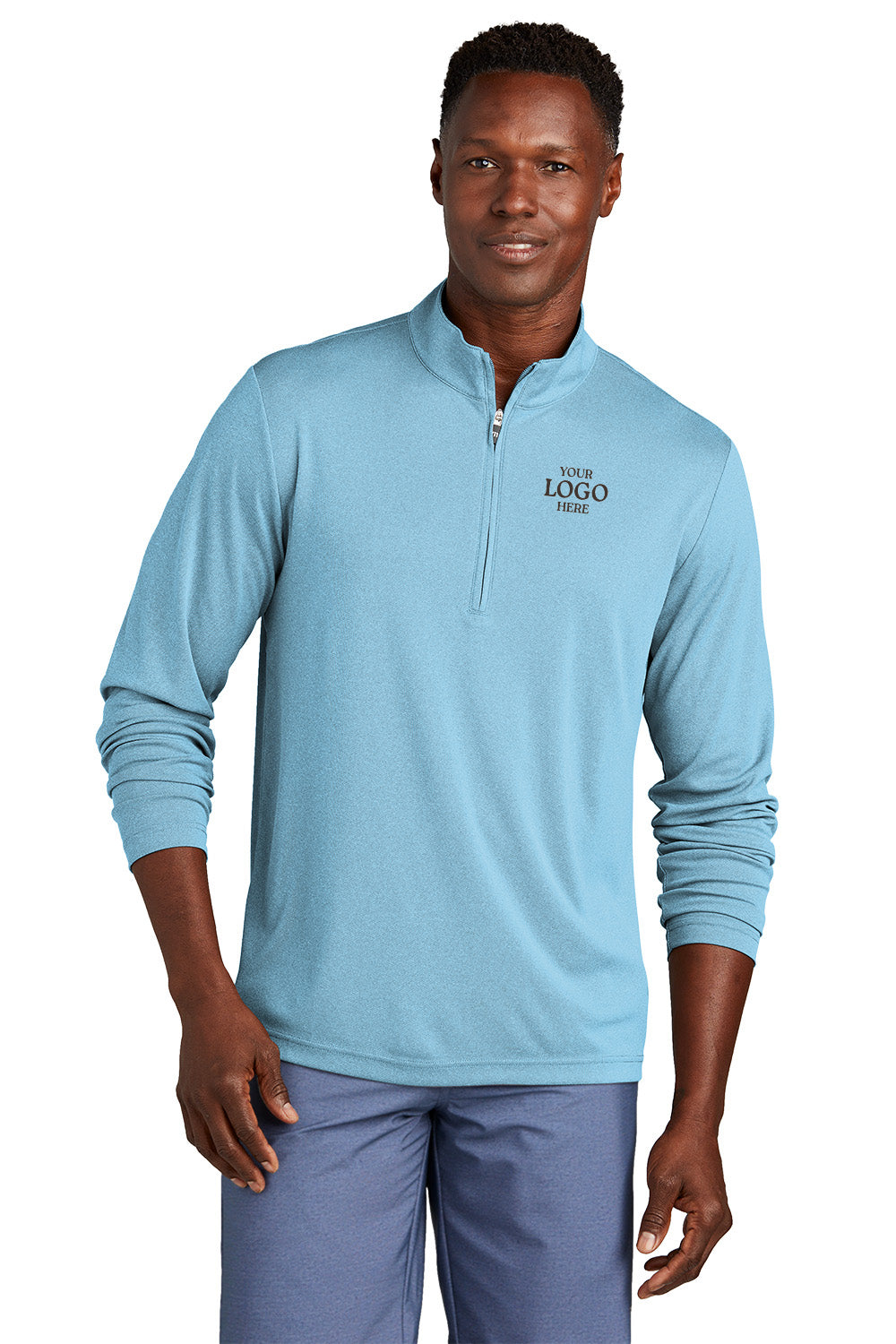 Man wearing a light blue pullover with a logo on a white background, embroidered TravisMathew Coto Performance 1/4-Zip