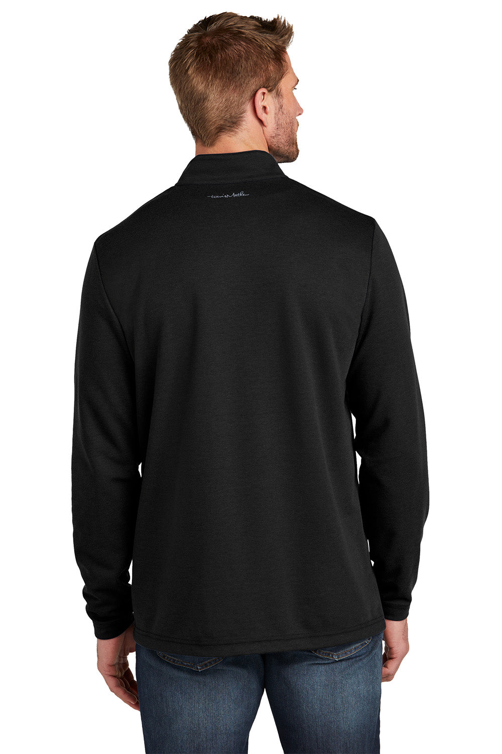 Man wearing a black long-sleeve shirt with a logo on the back against a white background TravisMathew Coveside 1/4-Zip, Embroidered