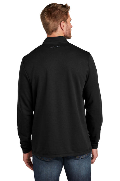 Man wearing a black long-sleeve shirt with a logo on the back against a white background TravisMathew Coveside 1/4-Zip, Embroidered