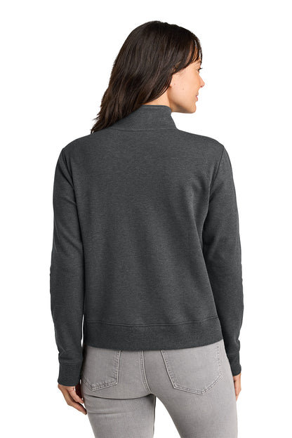 Woman wearing a dark gray sweater and light gray pants on a white background. TravisMathew Women's Ocean Villa 1/4-Zip, Embroidered