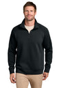 A man wearing a black quarter-zip pullover sweater with a stand collar, paired with beige pants, photographed against a plain white background. TravisMathew Momentum Shift 1/4-Zip, Embroidered