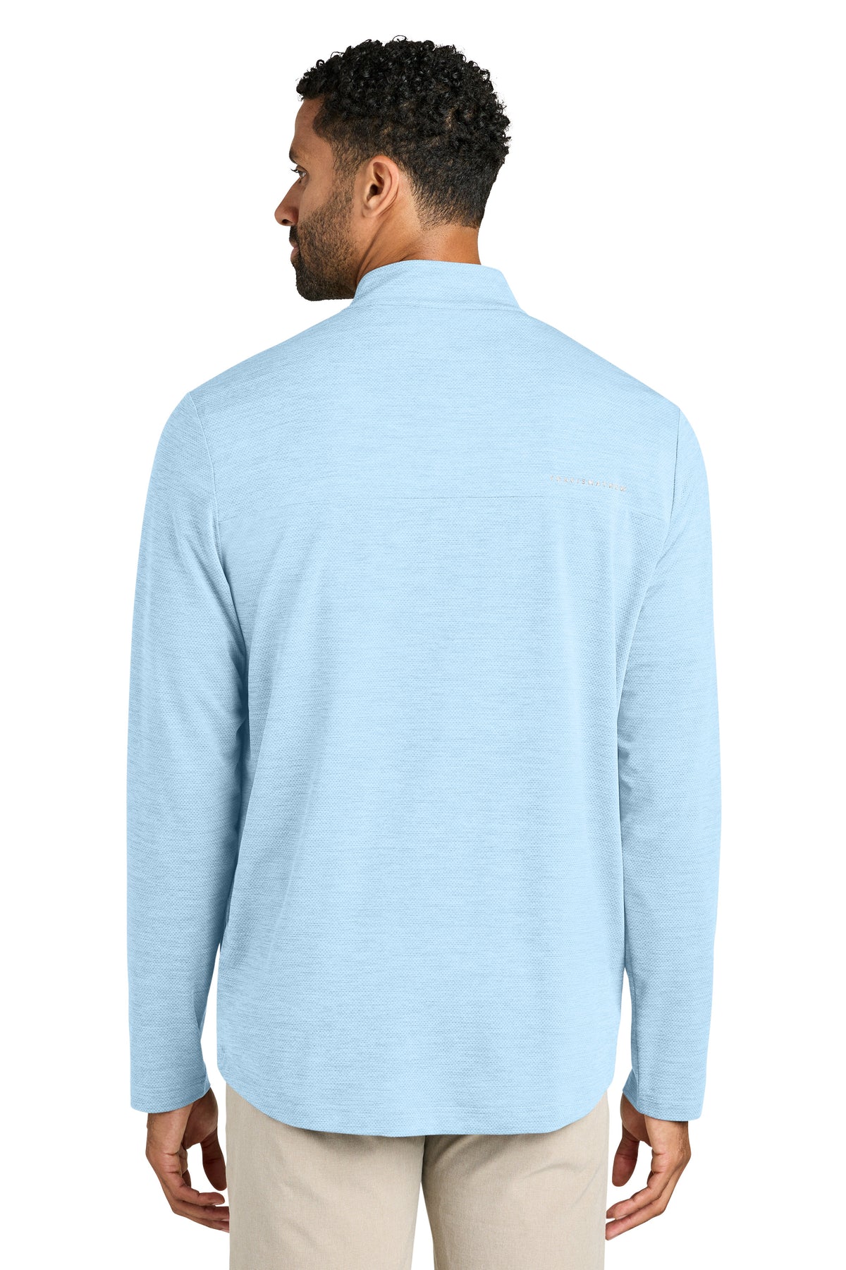 Man wearing a light blue long-sleeve shirt on a white background. TravisMathew Onward 1/2-Zip, Embroidered