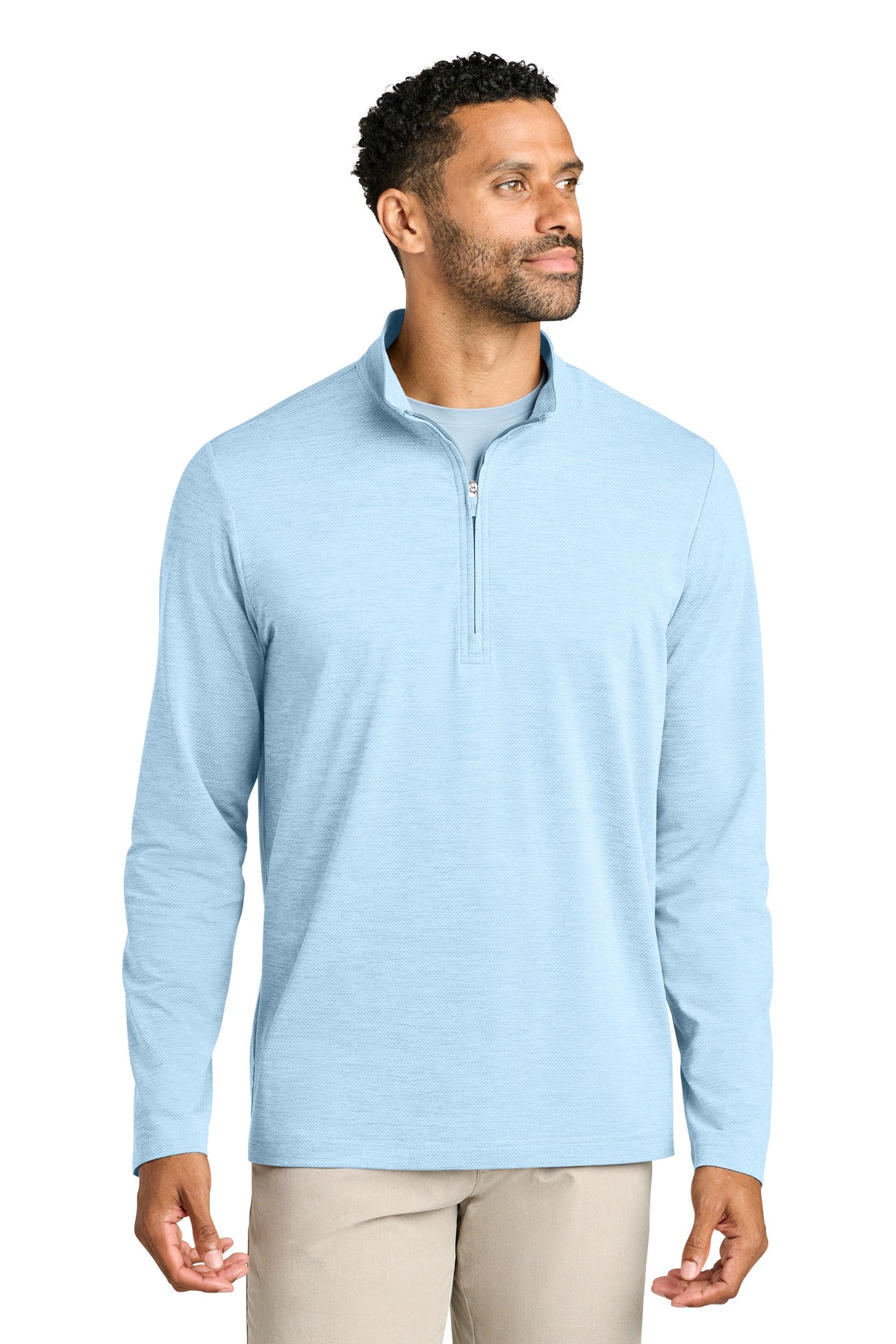 Man wearing a light blue pullover with a quarter zip on a white background. TravisMathew Onward 1/2-Zip, Embroidered