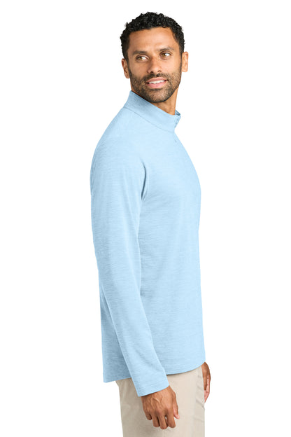 Man wearing a light blue long-sleeve shirt on a white background. TravisMathew Onward 1/2-Zip, Embroidered