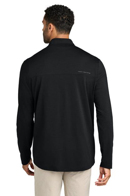 Person wearing a black long-sleeve shirt with a brand logo on the back, standing against a white background. TravisMathew Onward 1/2-Zip, Embroidered