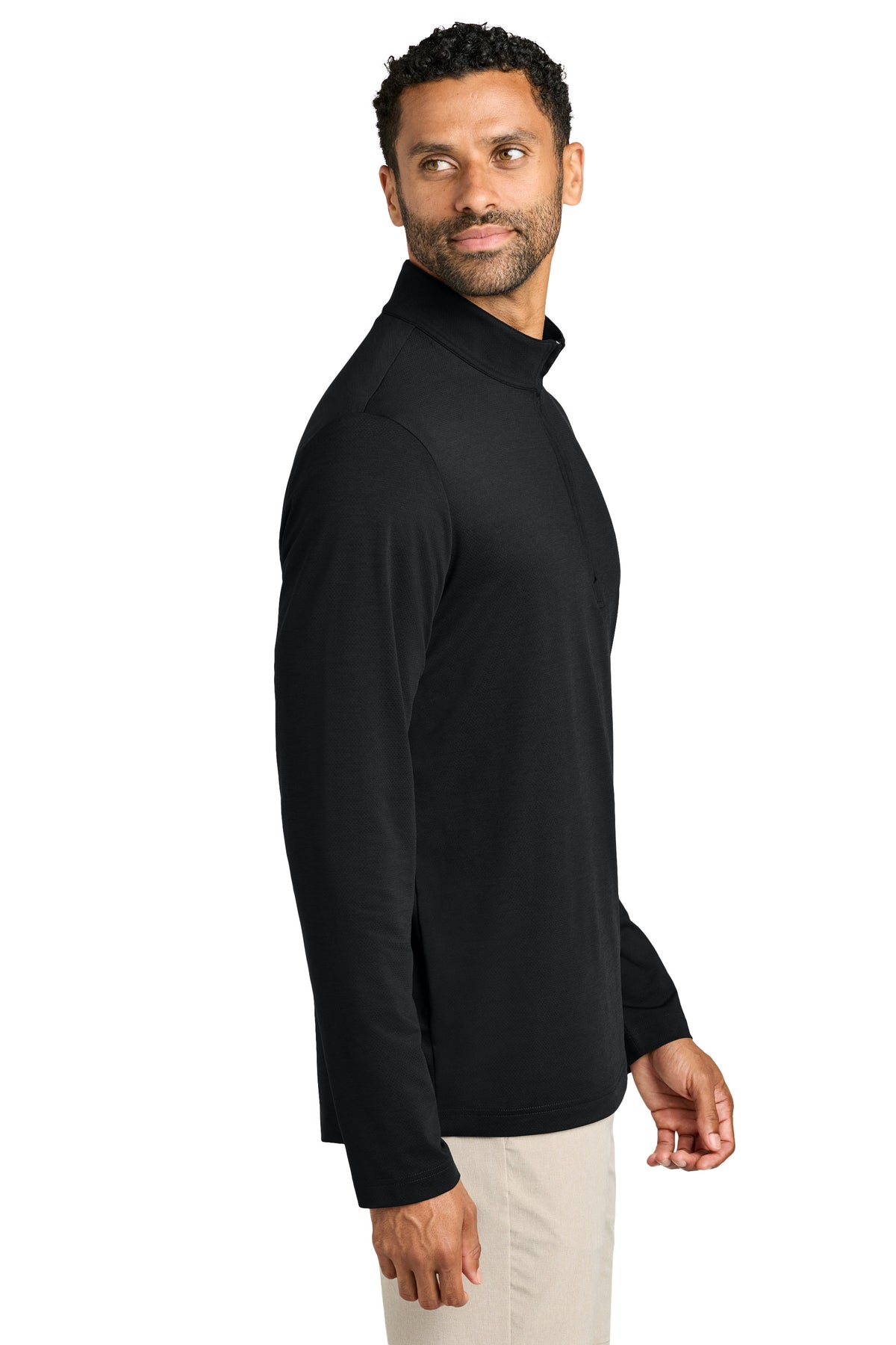 A man wearing a black long-sleeve mock neck shirt, shown from a side profile against a plain white background. TravisMathew Onward 1/2-Zip, Embroidered