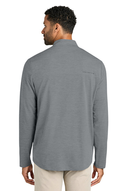 Man wearing a gray long-sleeve shirt with a small logo on the chest, standing against a white background. TravisMathew Onward 1/2-Zip, Embroidered
