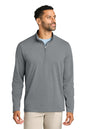 A man wearing a heather gray long-sleeve quarter-zip pullover shirt over a light blue undershirt, paired with beige pants, photographed against a solid white background. TravisMathew Onward 1/2-Zip, Embroidered