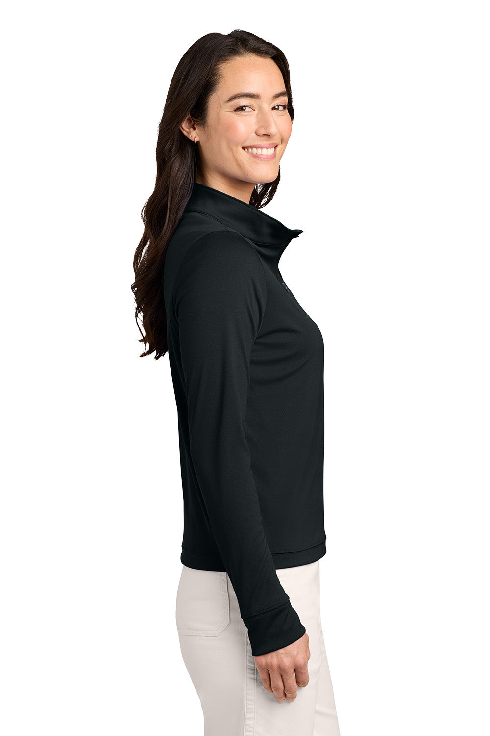 A woman shown in side profile wearing a black long-sleeve mock-neck or half-zip top and white pants against a plain white studio background. TravisMathew Women's Coto Performance 1/2-Zip, Embroidered
