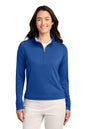 A woman modeling a royal blue long-sleeve quarter-zip pullover against a plain white background. TravisMathew Women's Coto Performance 1/2-Zip, Embroidered