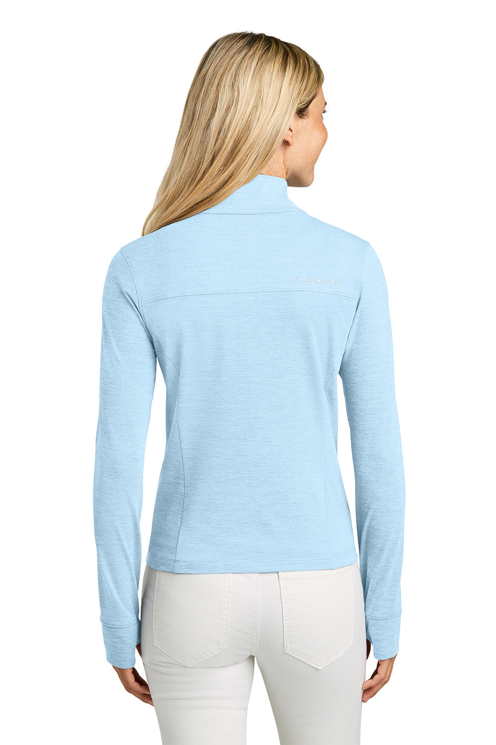 Woman wearing a light blue long-sleeve top on a white background. TravisMathew Women’s Onward 1/2-Zip, Embroidered
