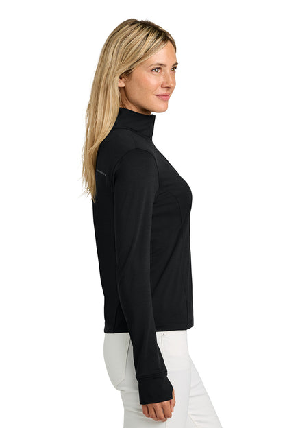 Woman wearing a black turtleneck sweater on a white background. TravisMathew Women’s Onward 1/2-Zip, Embroidered