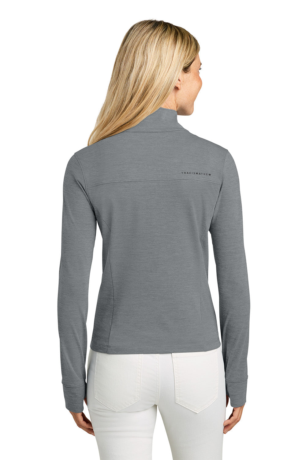 Woman wearing a gray long-sleeve shirt with a brand logo on the back, standing against a white background. TravisMathew Women’s Onward 1/2-Zip, Embroidered