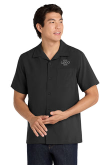 Man wearing a black polo shirt with a logo on a white background embroidered Port Authority ® Short Sleeve Performance Staff Shirt