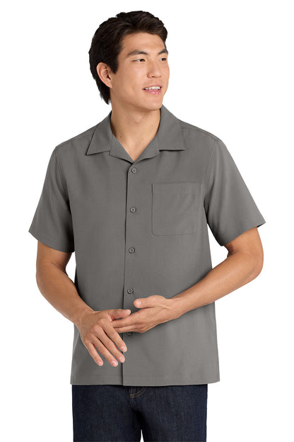 Man wearing a gray short-sleeve button-up shirt on a white background embroidered Port Authority ® Short Sleeve Performance Staff Shirt