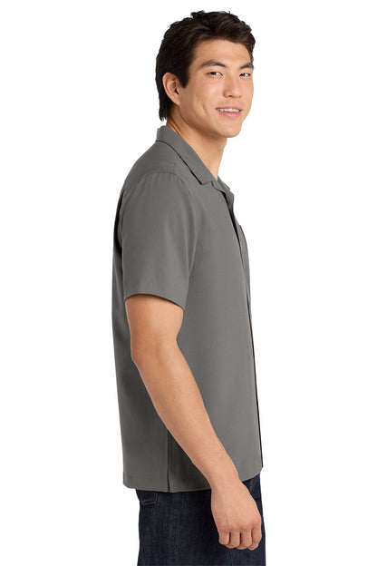 Man wearing a gray polo shirt on a white background embroidered Port Authority ® Short Sleeve Performance Staff Shirt
