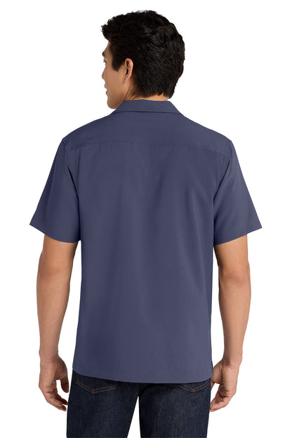 Person wearing a navy blue short-sleeve shirt on a white background embroidered Port Authority ® Short Sleeve Performance Staff Shirt