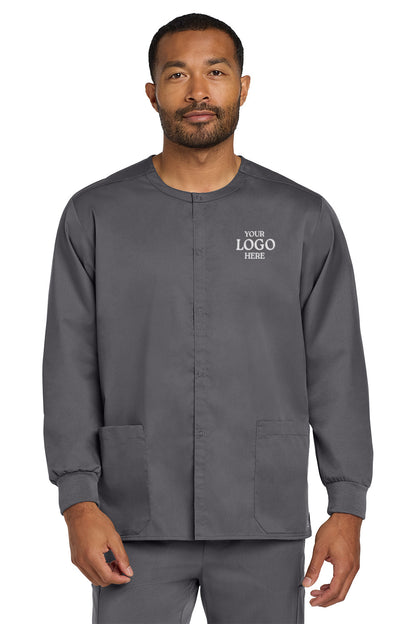 Man wearing a gray scrub top with customizable logo area on a white background Wink® Unisex WorkFlex Snap-Front Scrub Jacket, Embroidered