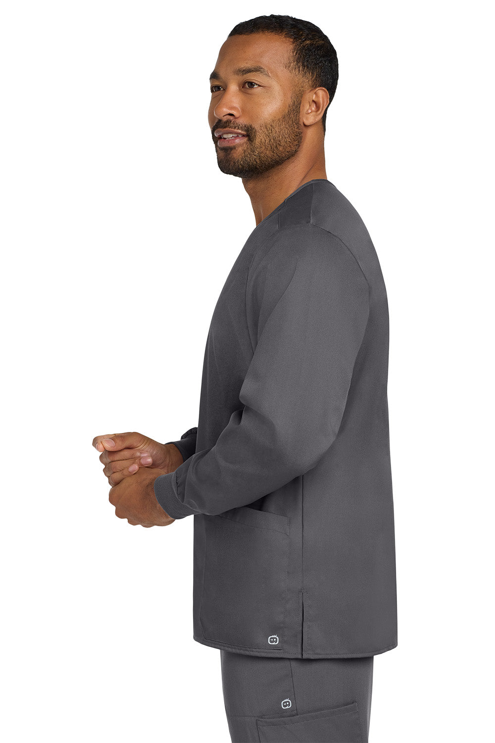 Man wearing a gray medical scrub top on a white background Wink® Unisex WorkFlex Snap-Front Scrub Jacket, Embroidered