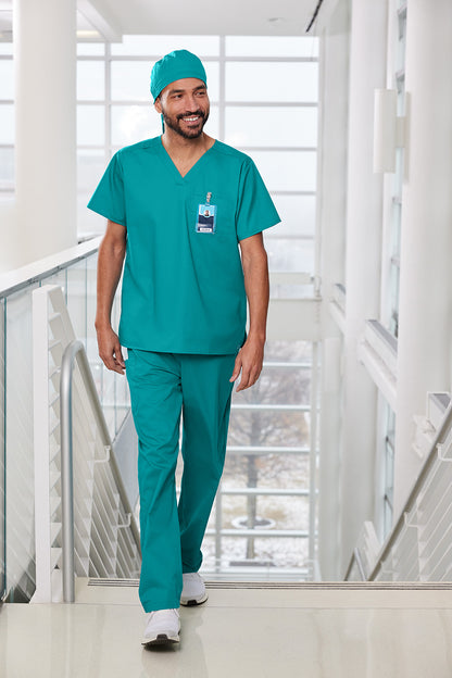 Man in teal medical scrubs walking in a modern building Wink® WorkFlex Scrub Cap, Embroidered