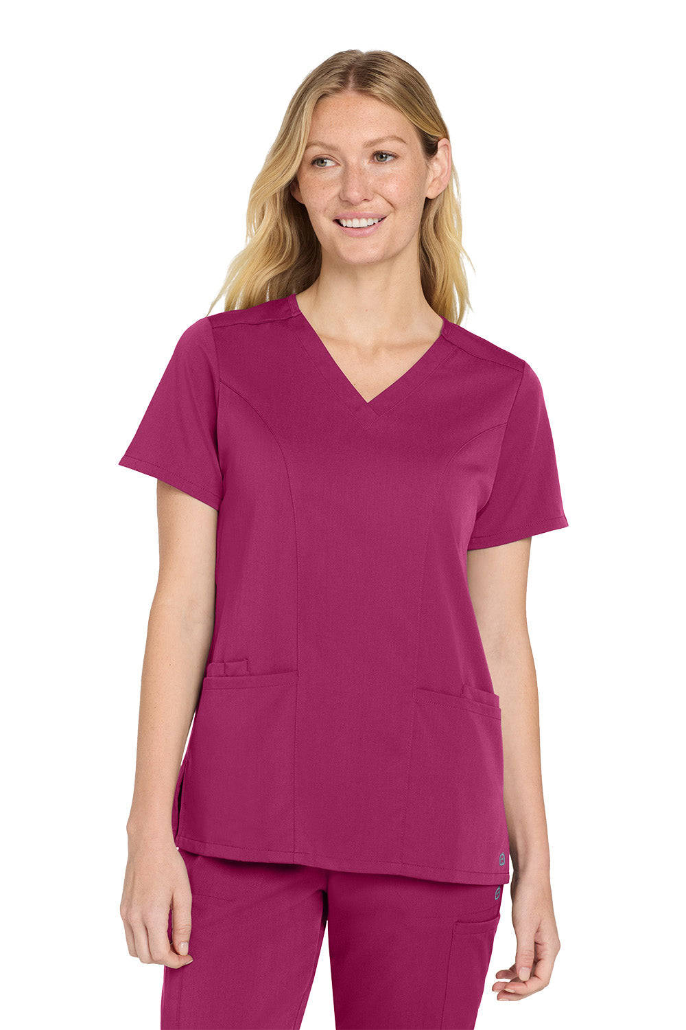Woman wearing a magenta scrub top and pants on a white background Wink® Women’s Premiere Flex™ Top, Embroidered