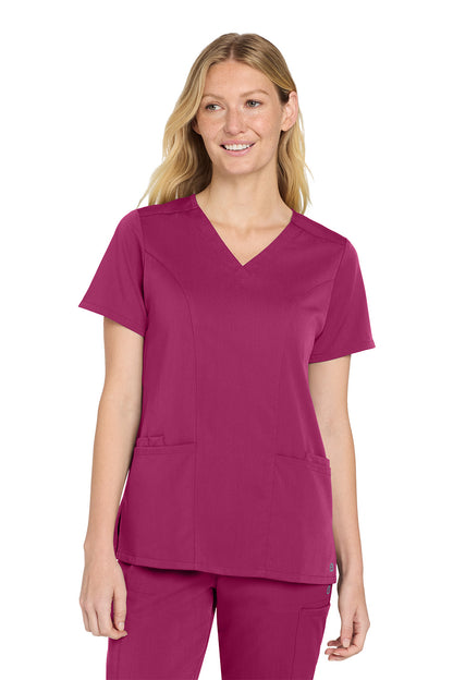Woman wearing a magenta scrub top and pants on a white background Wink® Women’s Premiere Flex™ Top, Embroidered