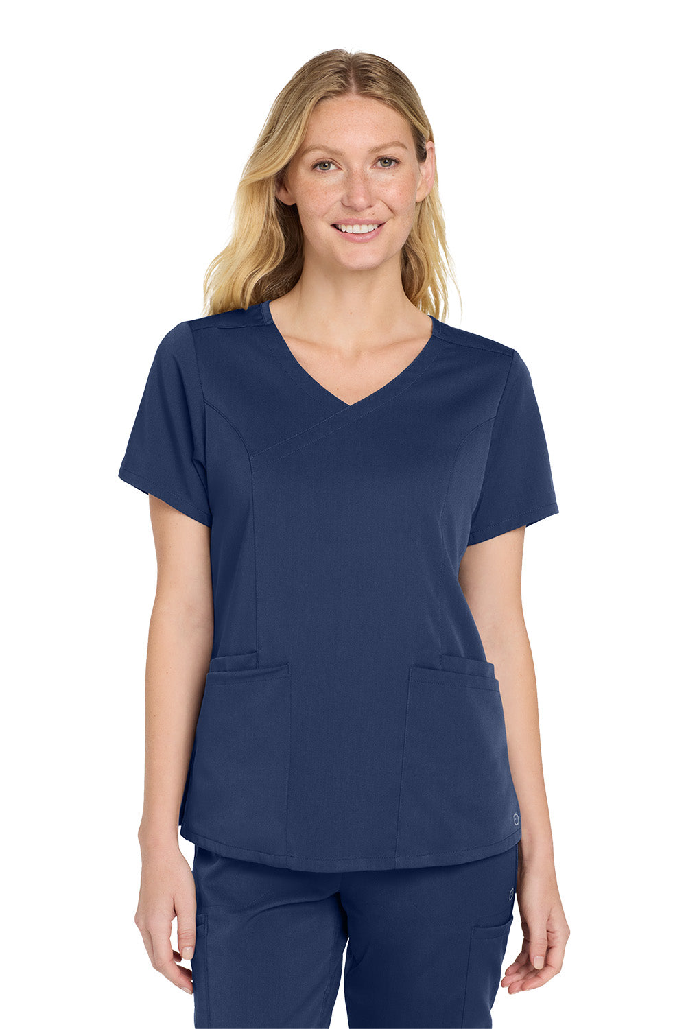 Woman wearing a navy blue scrub top with a white background Wink® Women’s Premiere Flex™ Top, Embroidered