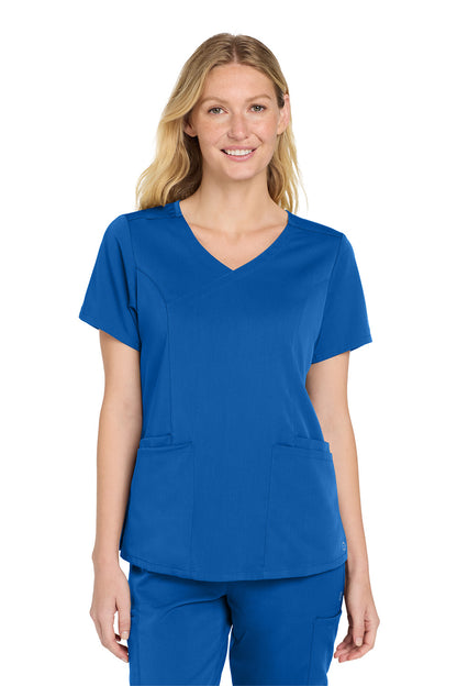 Woman wearing a blue scrub top and pants on a white background Wink® Women’s Premiere Flex™ Top, Embroidered