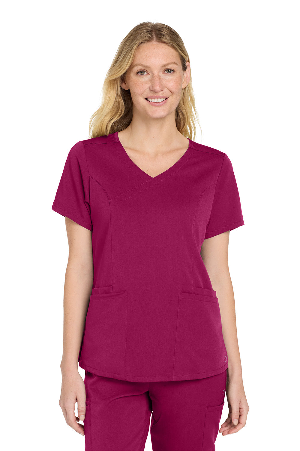 Woman wearing a magenta scrub top and pants on a white background Wink® Women’s Premiere Flex™ Top, Embroidered