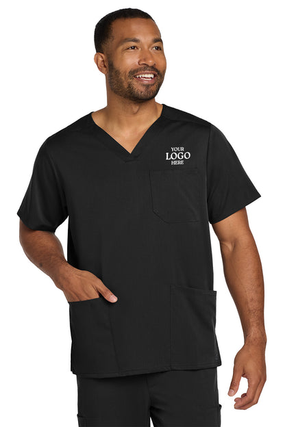 Man wearing a black scrub top with a customizable logo area on a white background Wink® Men's Premiere Flex™ V-Neck Top