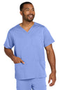 Man wearing a blue scrub set on a white background Wink® Men's Premiere Flex™ V-Neck Top