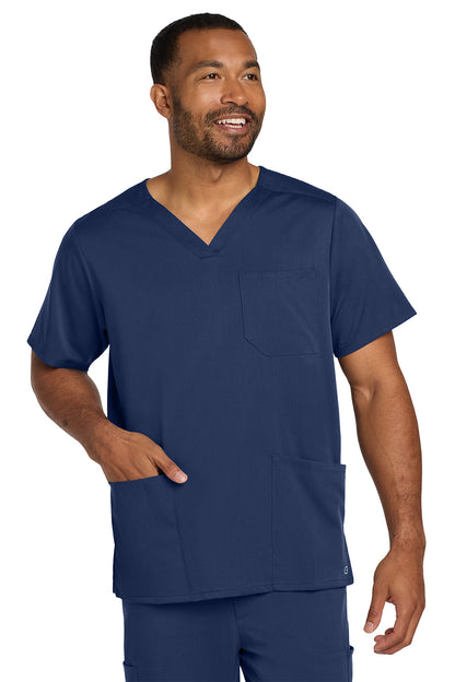 Man wearing a navy blue scrub top with a pocket on a white background Wink® Men's Premiere Flex™ V-Neck Top