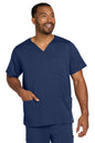Man wearing a navy blue scrub top with a pocket on a white background Wink® Men's Premiere Flex™ V-Neck Top
