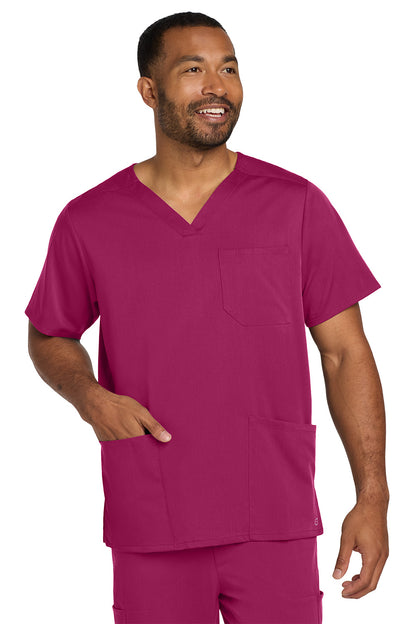 Man wearing a magenta scrub set on a white background Wink® Men's Premiere Flex™ V-Neck Top