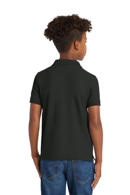 Person wearing a black polo shirt and blue jeans on a white background. Port Authority® Youth Core Classic Pique Polo, Embroidered by Helmsman Stitch Co.