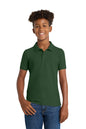 Person wearing a green polo shirt and blue jeans on a white background. Port Authority® Youth Core Classic Pique Polo, Embroidered by Helmsman Stitch Co.
